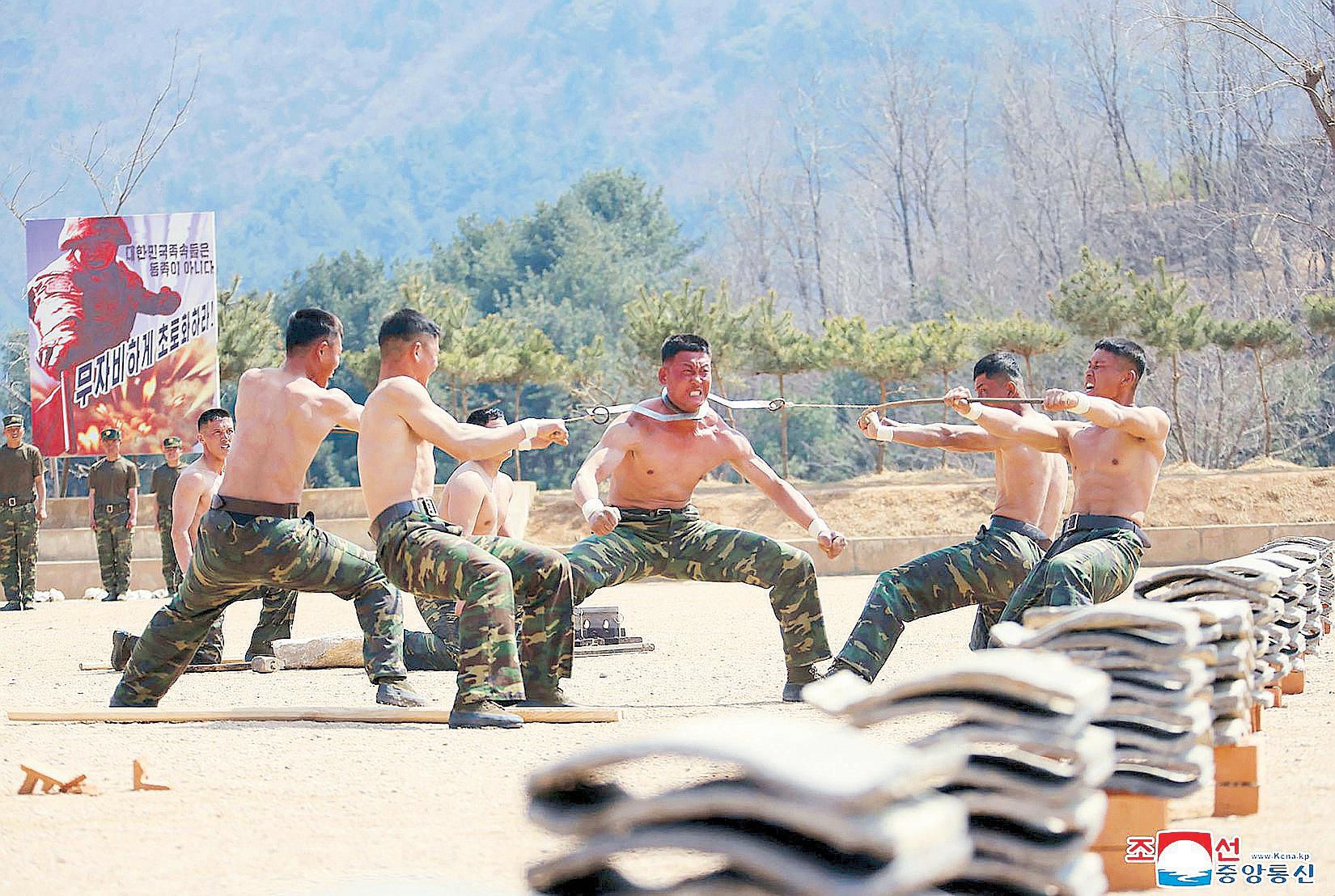 NoKor's Kim fires new sniper rifle while visiting troops