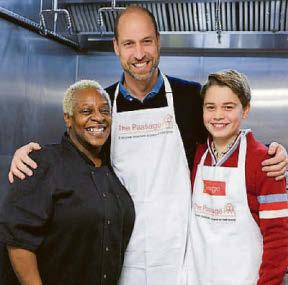 George gets 'stuck in' at party for the homeless... just like dad