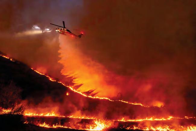 Pause in fierce winds helps.Los Angeles wildfire crews.