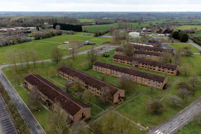 Pressure on Cooper to close 'prison-like' asylum camp