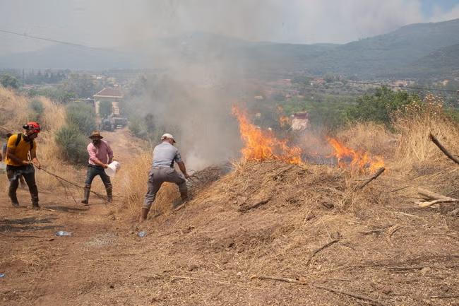 Tens of thousands flee fires in Turkey as Spain is set for its hottest June on record
