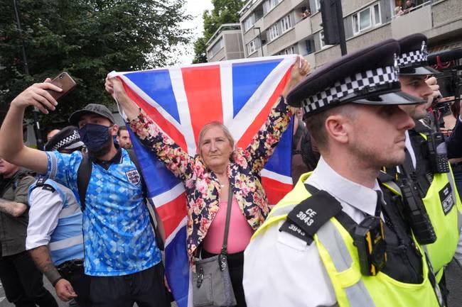 Masked group clashes with rivals outside asylum hotel