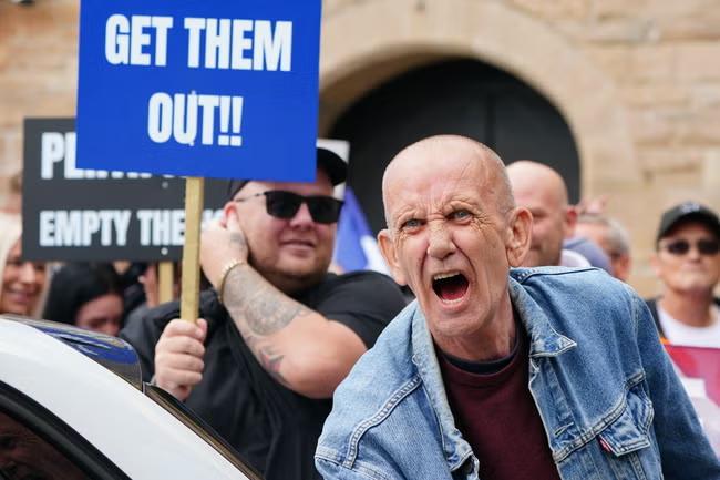 Protesters clash as tensions flare outside asylum hotels