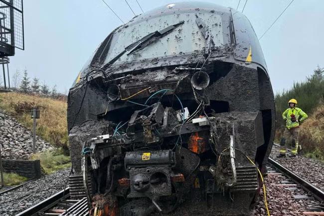 Four injured after train hits debris at 80mph and derails