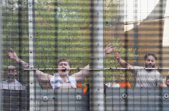 Migrants 'unnecessarily and routinely cuffed for hours'