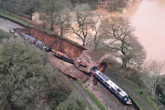 Boaters rescued after huge sinkhole opens up in canal