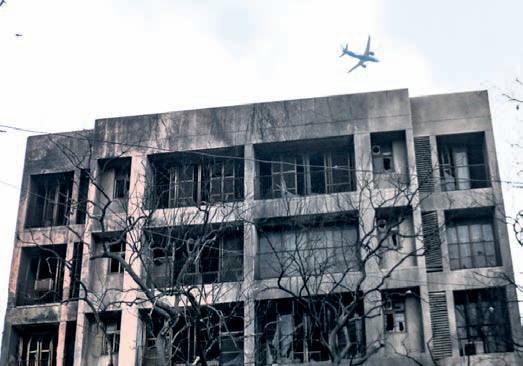 Silence, soot-covered buildings stand as grim reminders