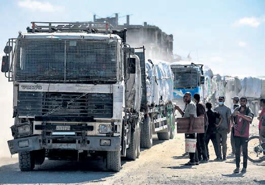 Aid trucks roll into Gaza as dispute over hostage bodies paused