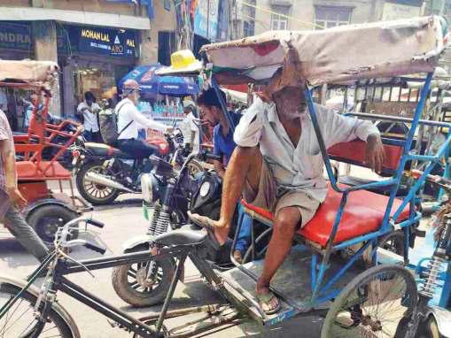 Delhi's rickshaw pullers, roadside vendors suffer as heat, pollution take a toll