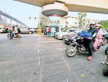 पेड़ों के पीछे छिपे साइनेज, जेब्रा क्रासिंग धूमिल