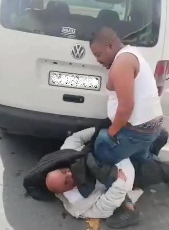 Taxi driver who was filmed stabbing motorist arrested