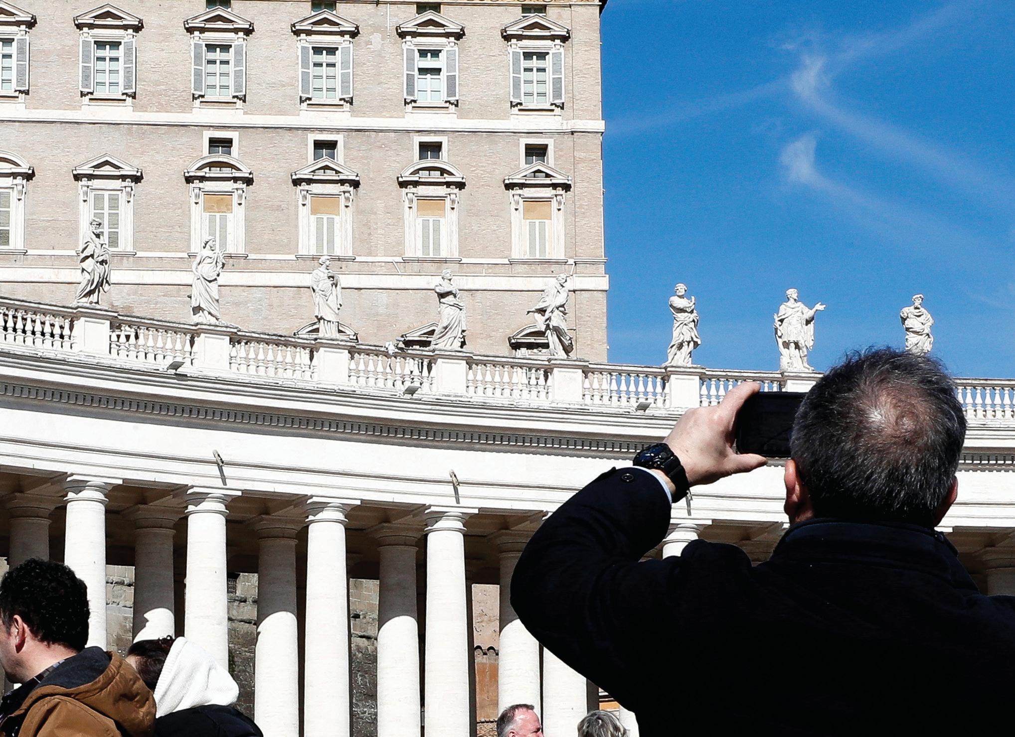In hospital, a resting Pope sits out Sunday mass