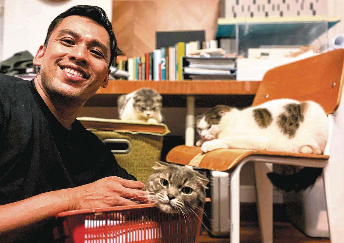 Full-time architect, part-time TV and radio host Khairudin Saharom keeps three cats in his office and two in his apartment