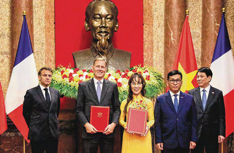 France, Vietnam sign Airbus, satellite deals as Macron visits Hanoi