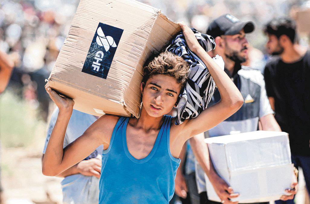 US-backed Gaza aid group halts distribution; at least 21 killed in Israeli air strike