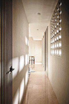 Two-bedroom unit is suffused with light, thanks to windows, screens and sculptural lamps