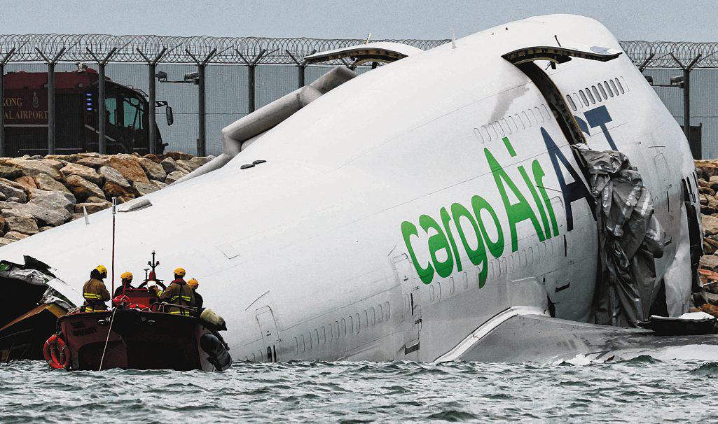 Cargo plane slides off runway in Hong Kong, killing two airport staff
