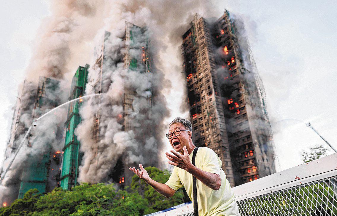 At least 13 dead and scores injured after fire engulfs residential high-rise blocks in HK