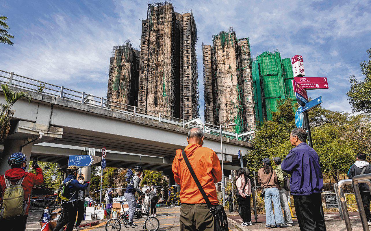 Mourners flock to site of deadly HK blaze as Beijing warns against protests