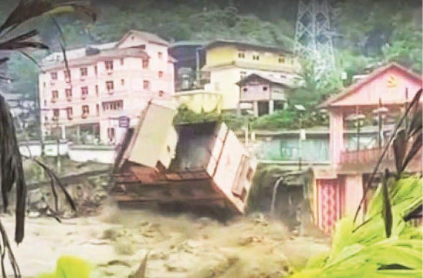 Hotel topples into river