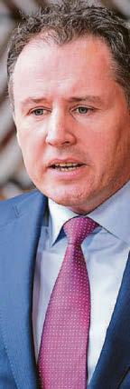 MINISTER DEFENDS TIE