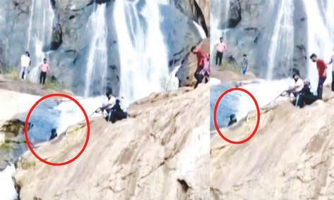 அருவி பாறையில் சிக்கி அந்தரத்தில் தொங்கிய மதுரை வாலிபர்