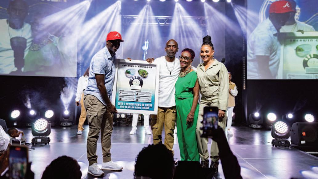 Caribbean Crooner Sherwin Gardne is surprised during album release concert with plaque celebrating 2 Billion Tik Tok views