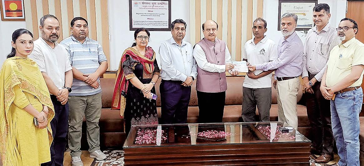 KU VC hands over welfare amount of Rs. 3.8 lakh for Dr. Krishna Kumar’s Treatment