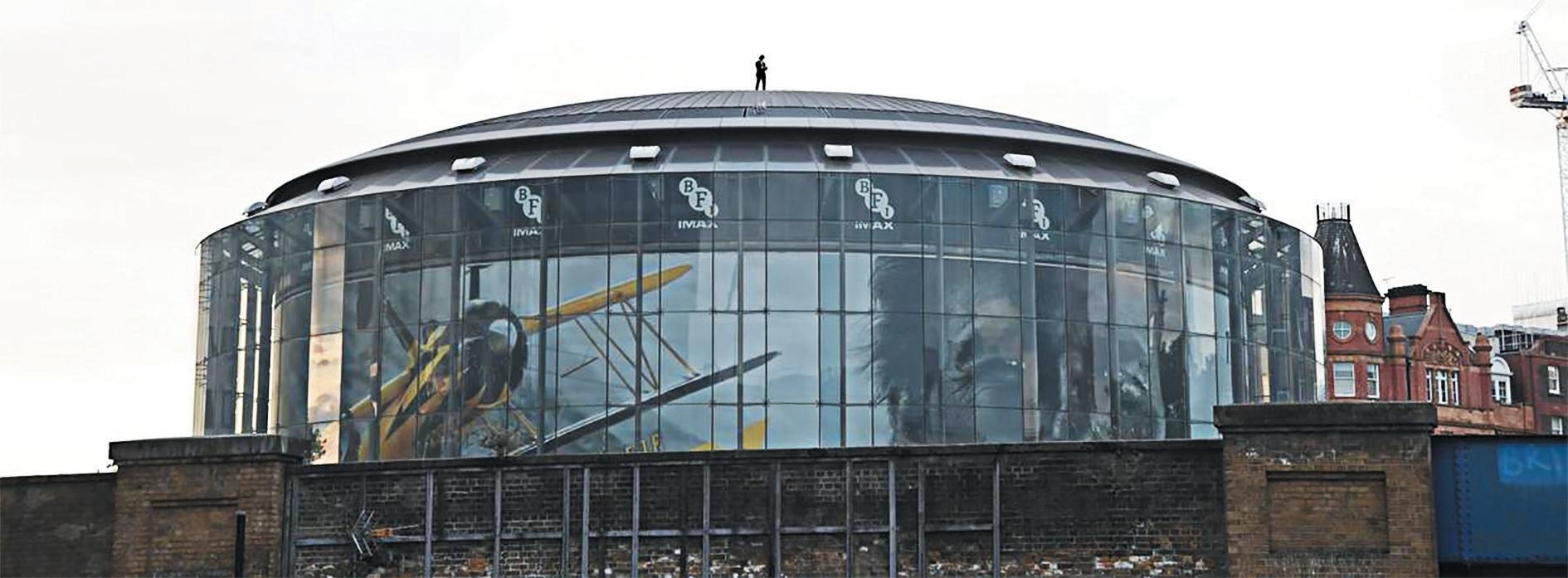 Tom Cruise surprises fans in London as he stands on the roof of BFI IMAX