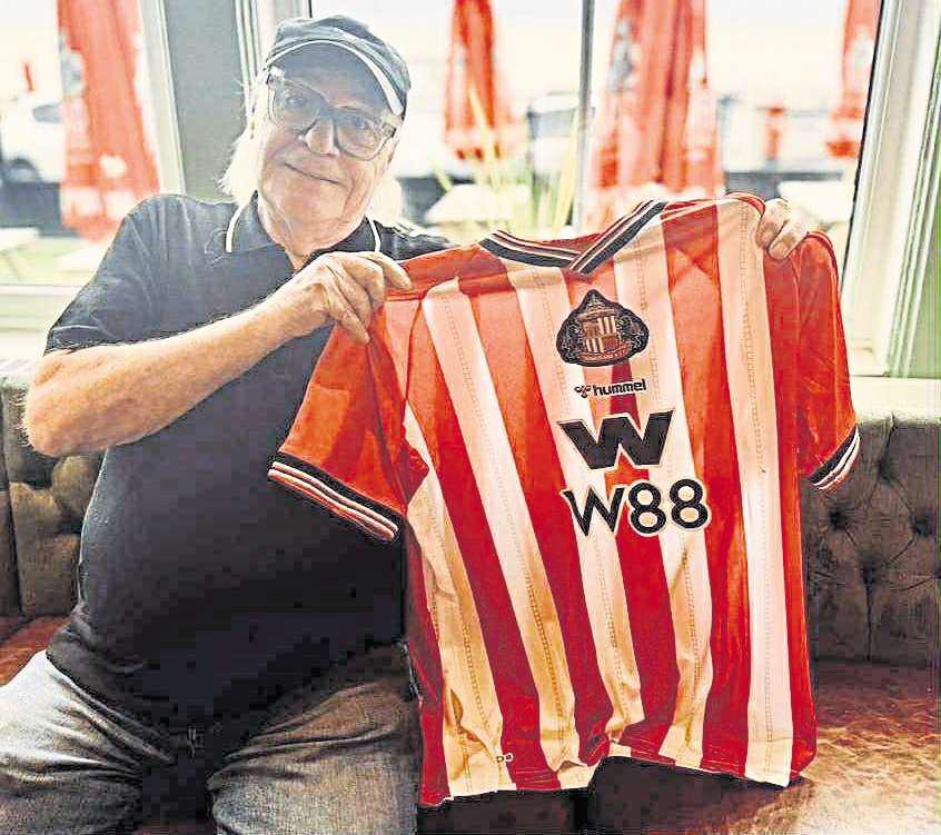 Comedy legend Mick pulls on a Black Cats shirt