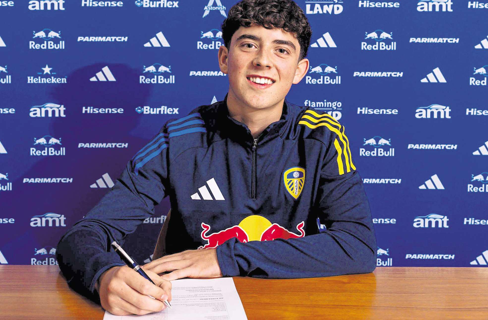 It's a deal! Ollie signs on the line of his first professional contract