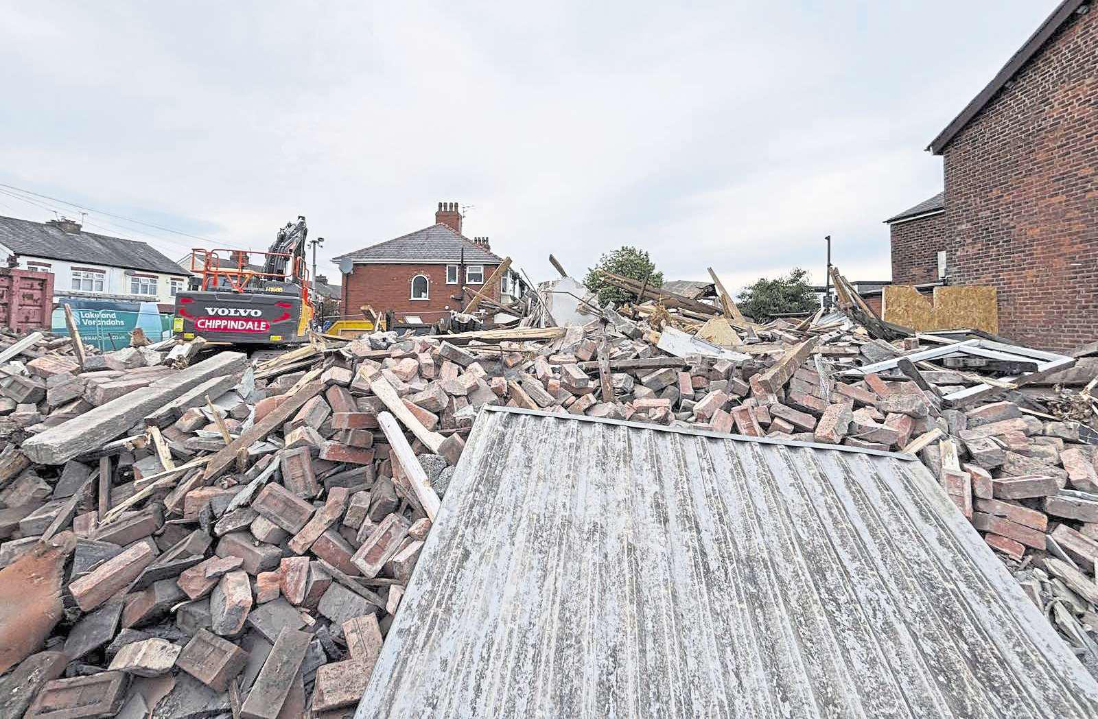 Police halt traffic as building collapses into busy city road
