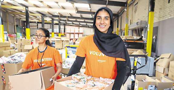 Leyland Amazon team packs hundreds of literacy kits to donate to families and children in need