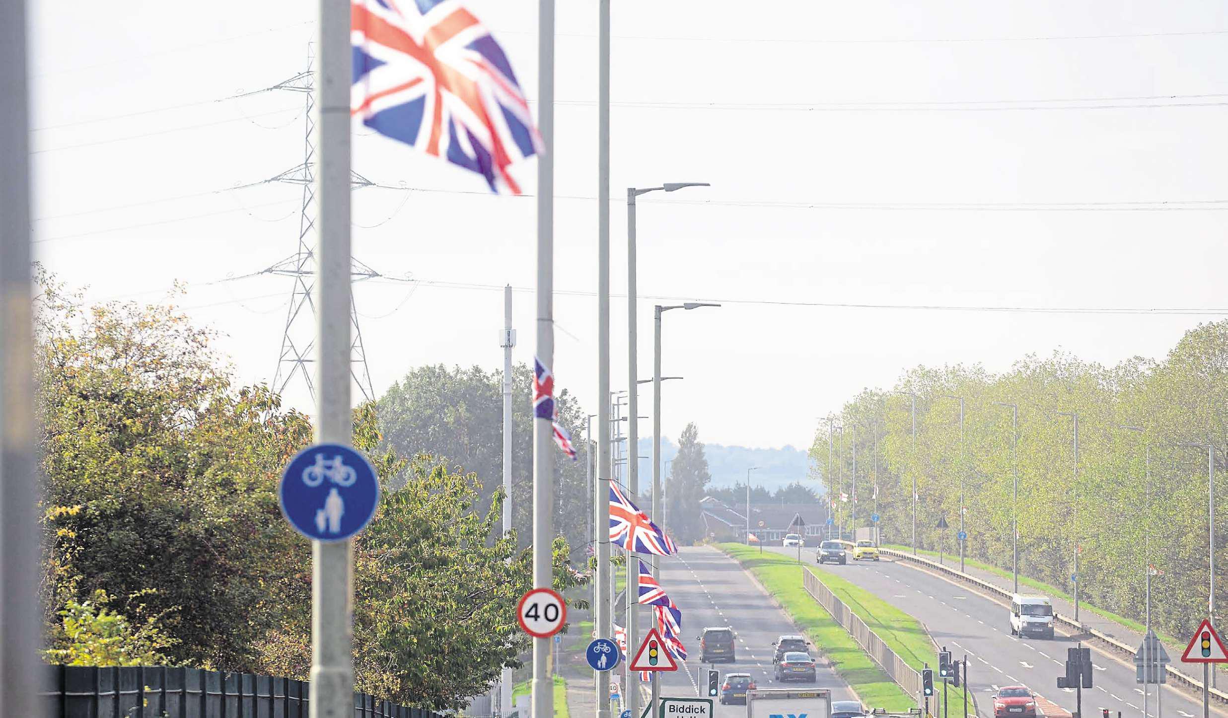 Flag Man vows to carry on amid critics' claims of driving division