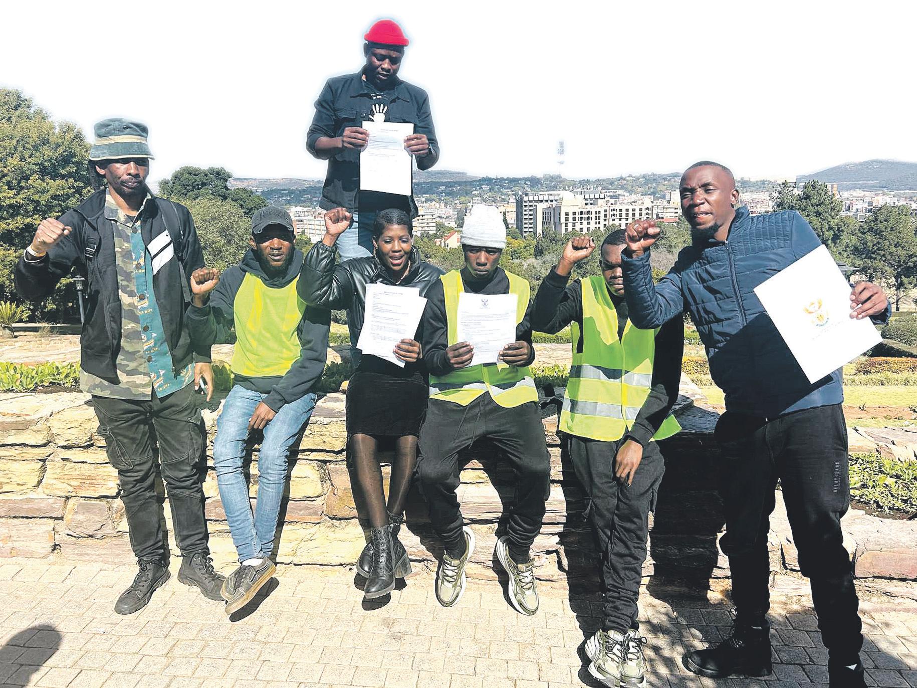 2 young men walk to Union Buildings for a cause