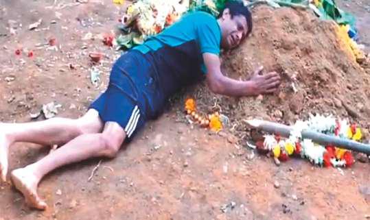 Heartbroken dad refuses to leave grave of son killed in stampede