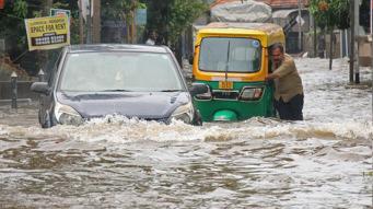 Heavy rain, strong winds lash district, flood warning issued