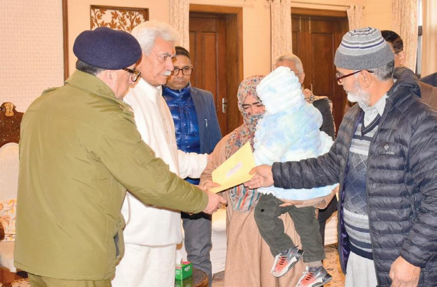 LG Sinha meets families of martyrs, hands over appointment letters to NOKS