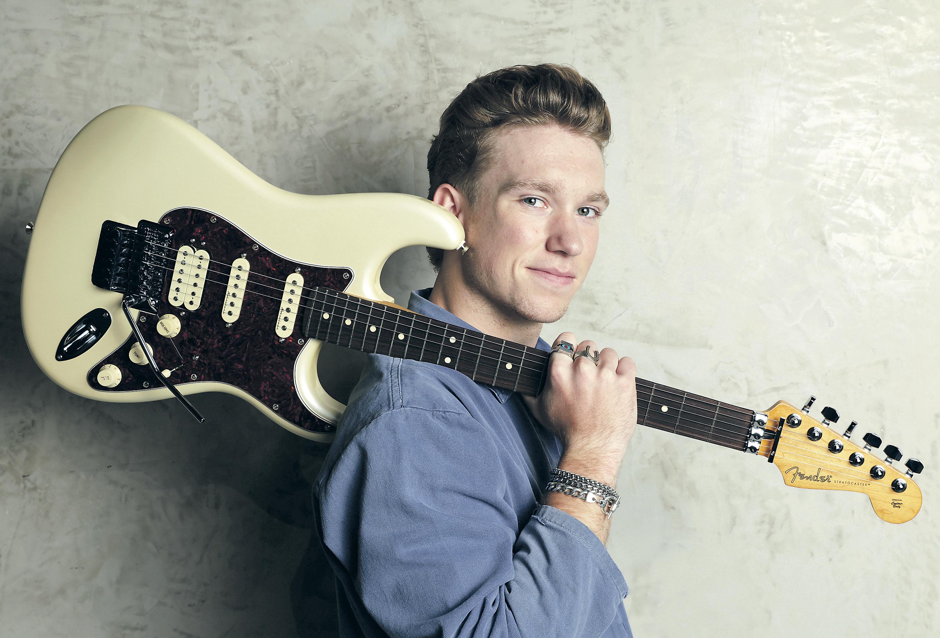 WIELDING MORE THAN HIS GUITAR