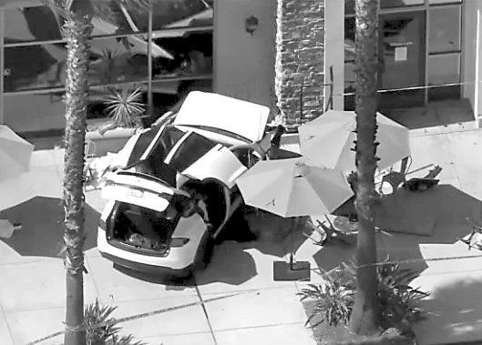 Woman pinned under Tesla dies