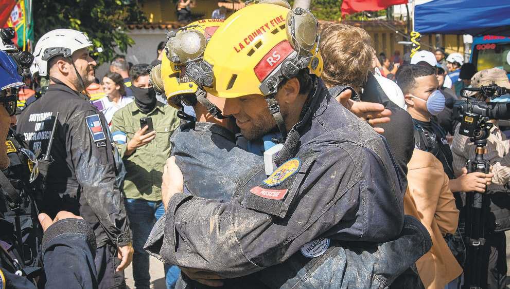 L.A. firefighters help unearth quake survivor